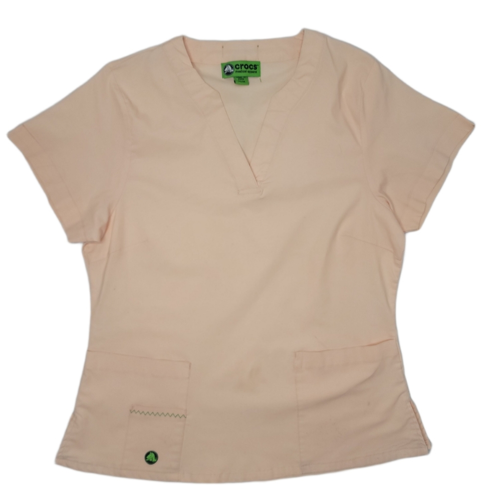 Crocs scrubs top light orange with pockets size medium.